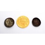 A Pope Pius 1 Scudo gold coin, 1862; and two other coins.