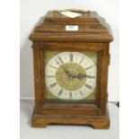 A German oak-cased mantel clock.