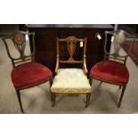 A pair of Edwardian hall chairs, and another.