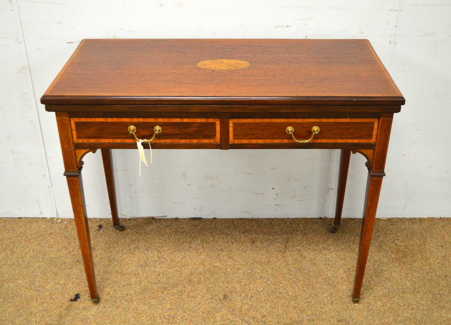 An Edwardian card table.