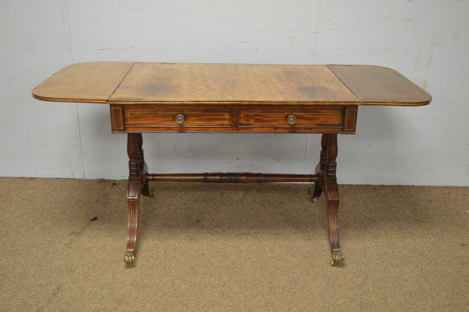 A Regency mahogany and brass inlaid sofa table.