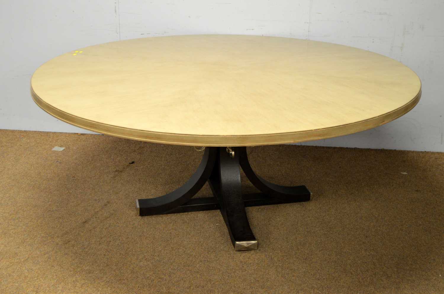 A large painted wood circular dining table.