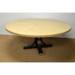 A large painted wood circular dining table.