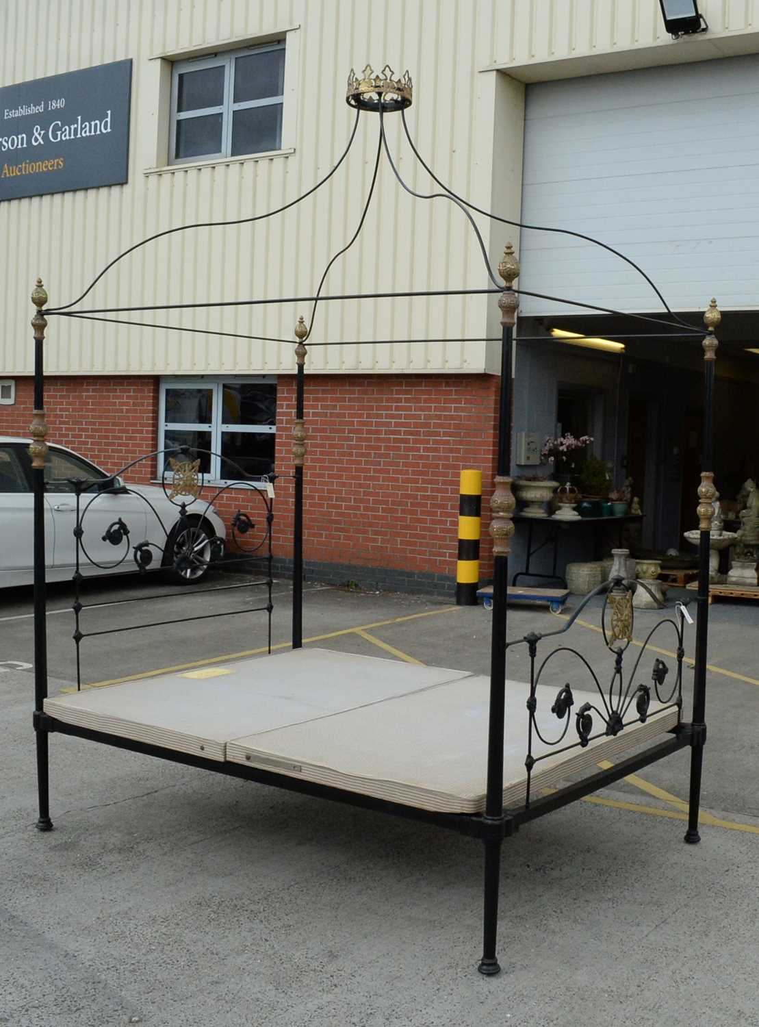 An ornate wrought metal four poster bed