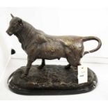 A bronze figure group of a bull