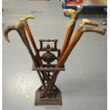 Victorian stick stand; and a selection of walking sticks, various.