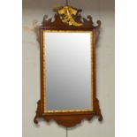 A Georgian-style mahogany and gold-painted wall mirror.
