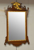 A Georgian-style mahogany and gold-painted wall mirror.