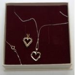 Two diamond set heart shaped pendants