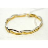 An 18ct white and yellow gold bracelet,