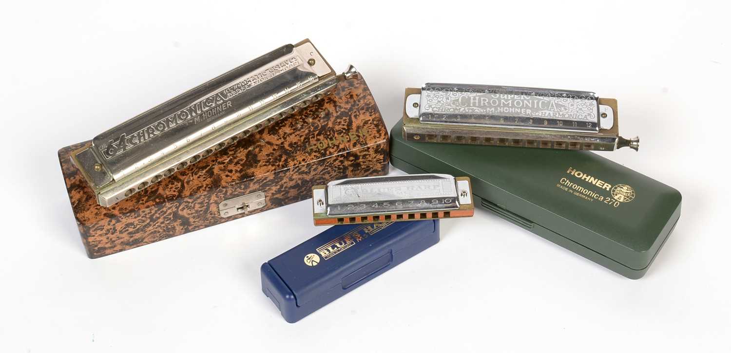 Three Hohner harmonicas