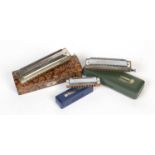 Three Hohner harmonicas