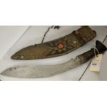 A Kukri knife, in sheath.