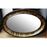 A Japanese style black lacquered and painted oval wall mirror.