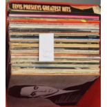 A collection of Elvis Presley and other vinyl LPs