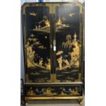 A mid 20th Century black lacquered wardrobe decorated chinoiserie designs.