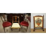 A pair of Edwardian hall chairs, another chair and a Victorian rosewood firescreen.