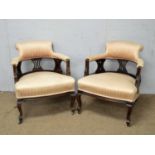 A pair of late Victorian tub chairs