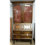 An early 20th century stained oak bureau bookcase.