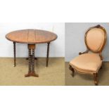 A Victorian carved walnut easy chair and a Sutherland table