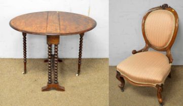 A Victorian carved walnut easy chair and a Sutherland table