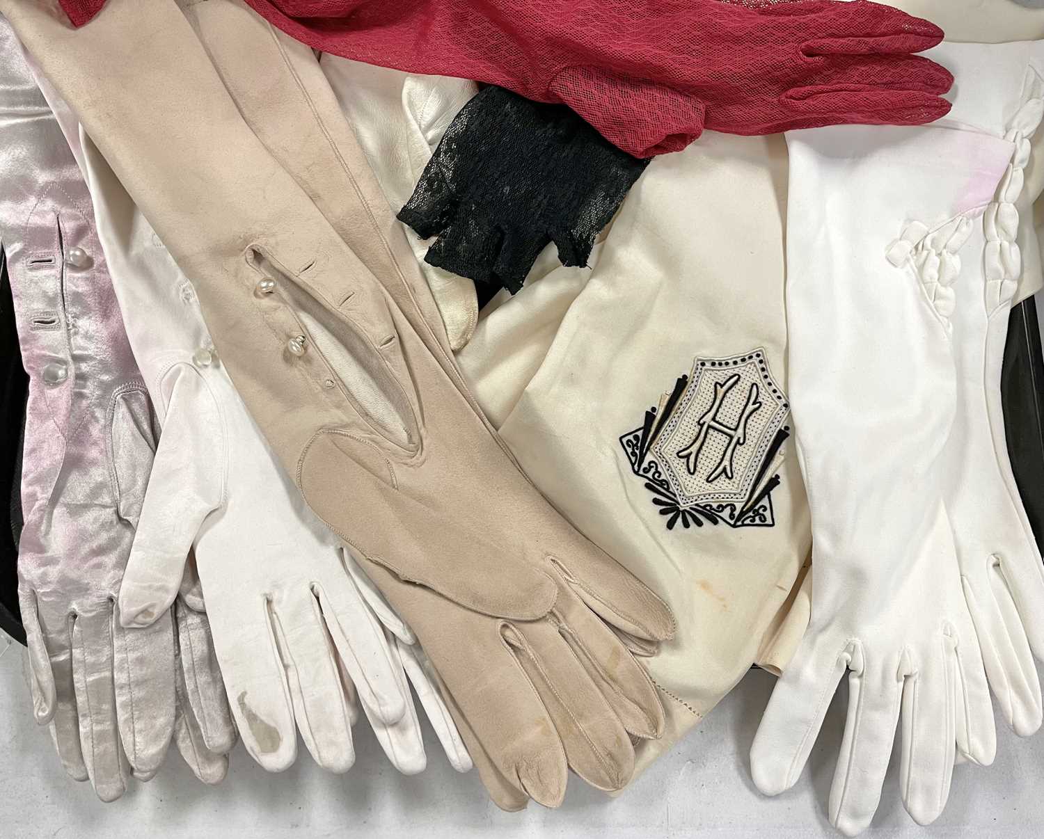 A selection of ladies' evening gloves and a 1930s gentleman's silk scarf