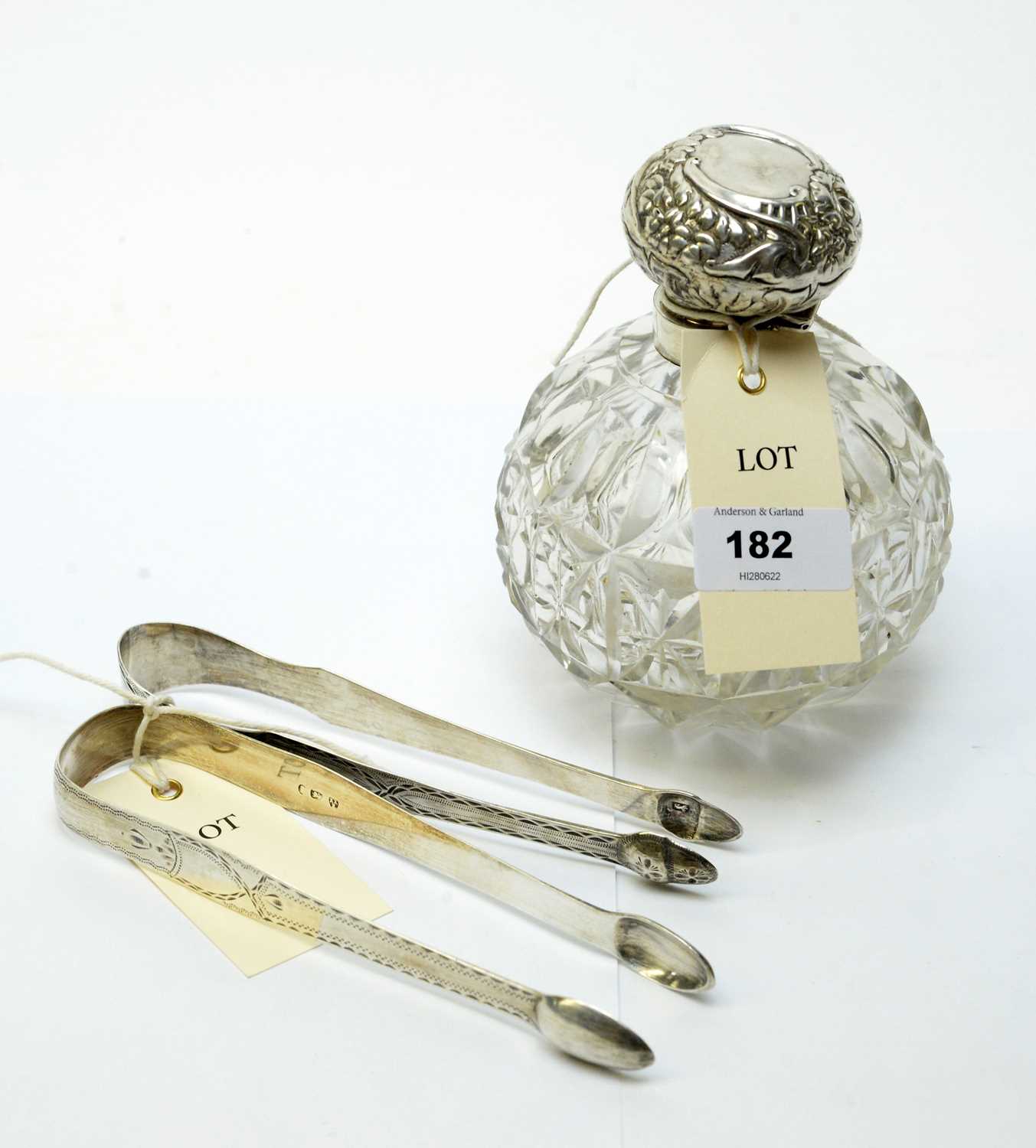 Tongs, scent bottle and spoons.