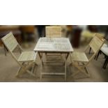 A teak folding garden table and three matched chairs