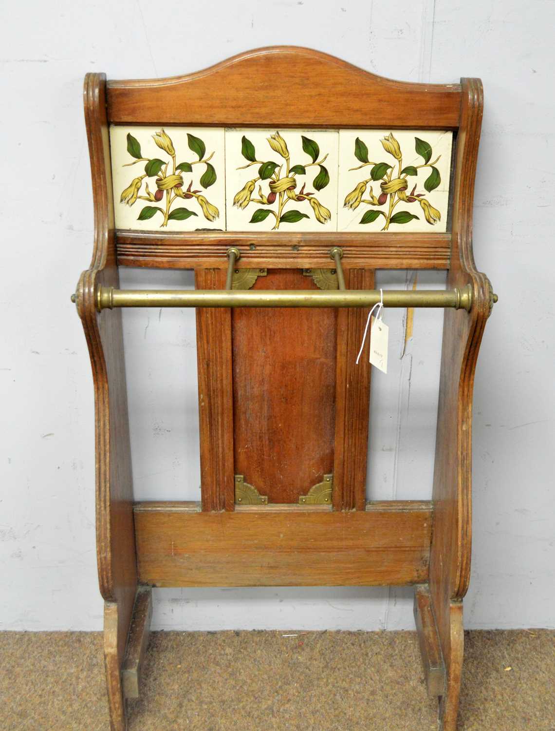 An Edwardian walnut and brass tile back stick stand