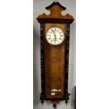 A walnut and ebonised Vienna wall timepiece.