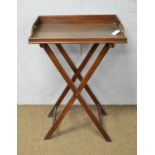 A vintage mahogany Butler's tray on folding stand