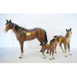 A Beswick figure of a horse and two smaller Beswick horses
