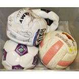 A selection of signed footballs.