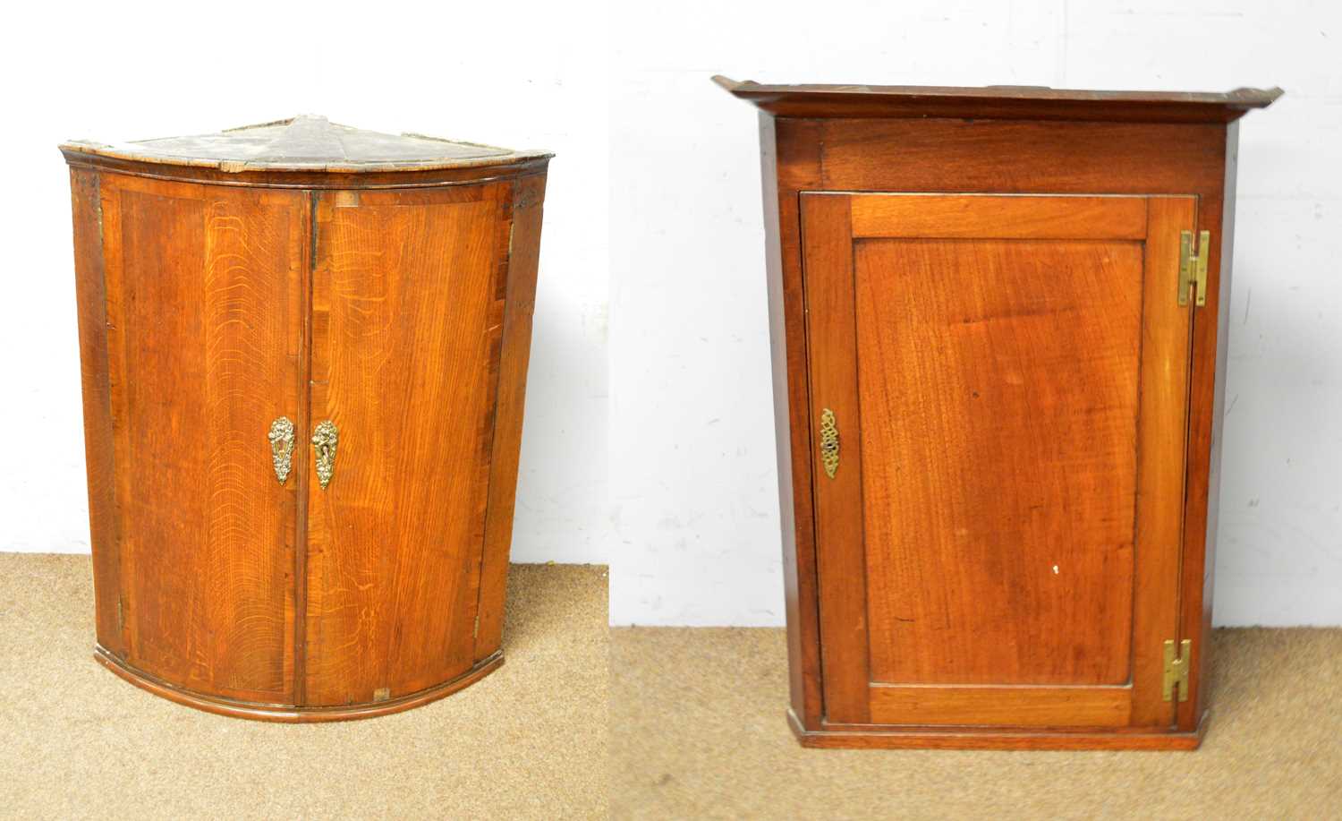 A Georgian style walnut sofa table and two corner cupboards.