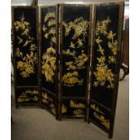 A Japanese black lacquered and gilt painted folding dressing screen