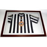 A Newcastle United replica football shirt, signed.