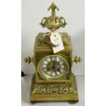 An ornate brass mantel clock.
