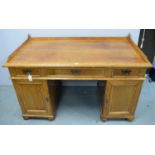 An early 20th Century oak pedestal desk.