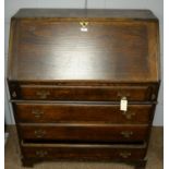 An oak writing bureau.