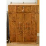 An Art Deco burr walnut fitted gentleman's wardrobe