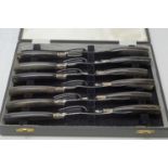 A set of six steak knives and forks, by Walker & Hall,