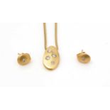 An 18ct yellow gold diamond pendant and earrings,