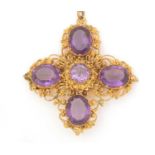 A 19th Century amethyst and yellow metal cross-pattern pendant/brooch,