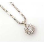 A diamond cluster pendant,