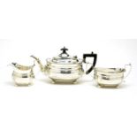 A George V silver three piece tea service, by Charles Stuart Harris