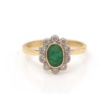 An emerald and diamond cluster ring,