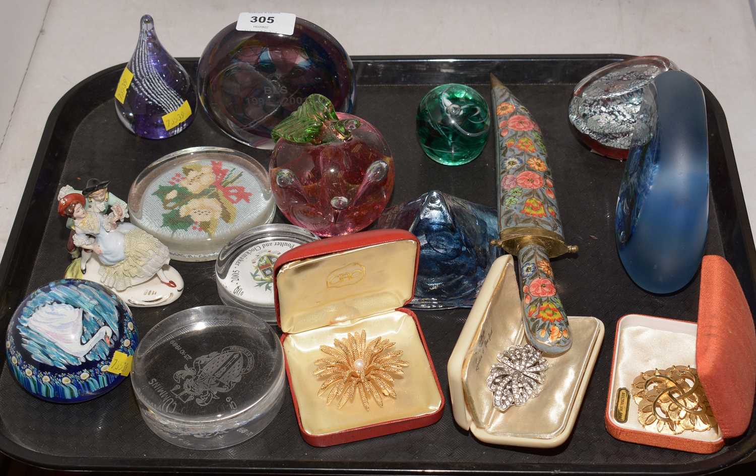 A selection of glass paperweights and other decorative items.