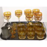 A Bohemian clear and amber glass suite of glasses.