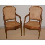 A pair of late 19th Century French style oak bergere armchairs.