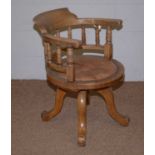 A 1920s oak swivel office chair.